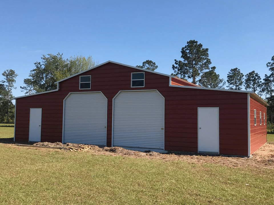 A Red metal barn from Outdoor Options in Eatonton, Georgia with 2 rollup doors and 2 walk in doors