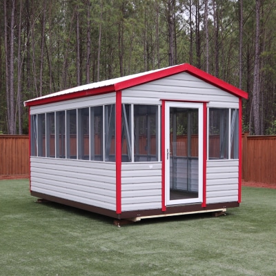 An outdoor screen room shed measuring 10 feet by 16 feet, featuring pewter grey siding and eye-catching red trim. The screen room shed is a perfect outdoor entertainment and relaxation area that is protected from pesky mosquitoes and other outdoor pests. Its spacious design and well-ventilated screen walls provide an airy and comfortable atmosphere for enjoying outdoor activities while being shielded from the elements. The combination of stylish and durable pewter grey siding with vibrant red trim adds a bold and modern touch to any backyard. Whether used for hosting parties, family gatherings, or as a personal sanctuary for relaxation, this screen room shed is a practical and stylish addition to any outdoor space.